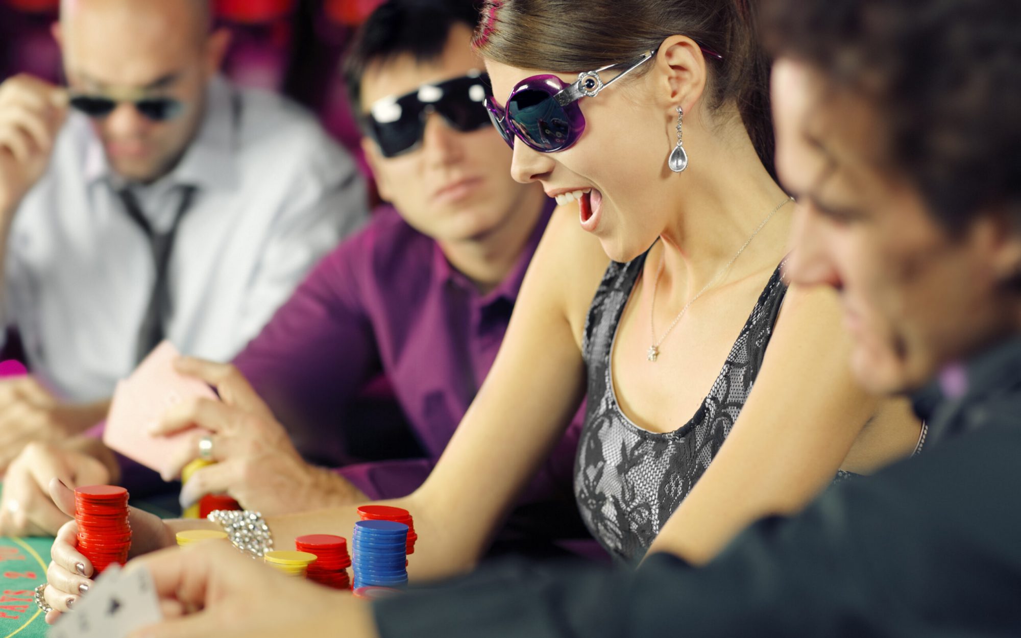 boys and girls playing poker  in casino